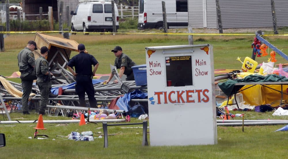 Investigators inspect the site of a circus tent that collapsed Monday during a show by the Walker Brothers International Circus at the Lancaster Fair grounds in New Hampshire Tuesday. (Jim Cole/AP)