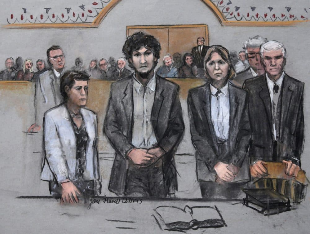 In this May 2015 courtroom sketch, Boston Marathon bomber Dzhokhar Tsarnaev (center) stood with his defense attorneys as his death sentence was read in federal court in Boston. (Jane Flavell Collins via AP)
