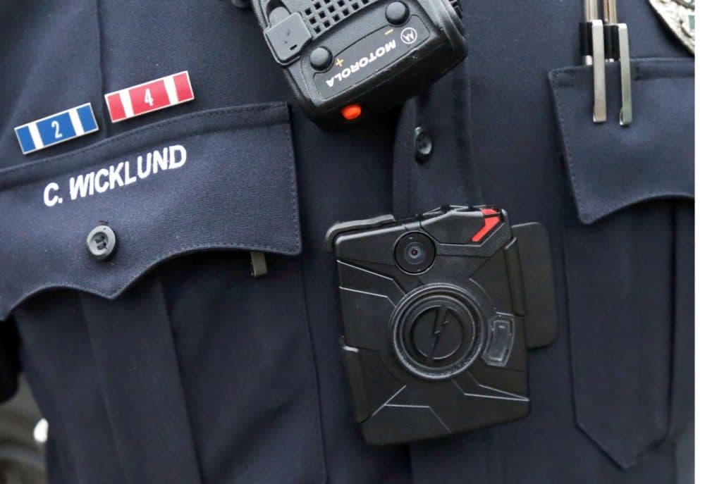 In this Nov. 5, 2014 file photo, a Minnesota police officer wears a body camera.  Police in Lowell are considering a 30-day pilot of the technology. (Jim Mone/AP/File)
