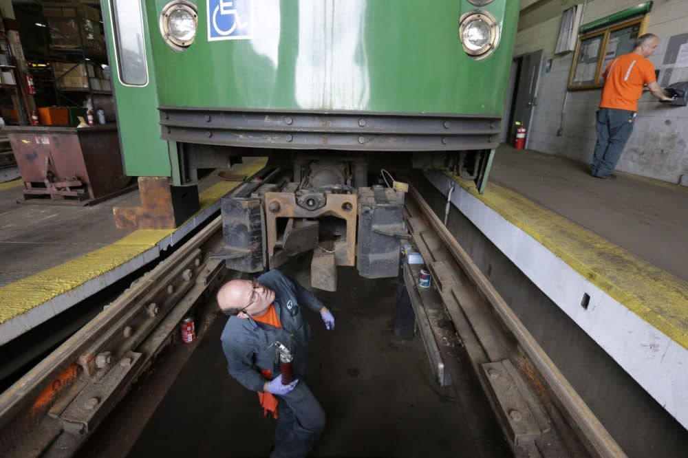 Light rail repairer Fred Goforth, of Nashua, N.H., works on a railcar coupling at the Massachusetts Bay Transportation Authority's Riverside maintenance facility in Newton, Mass. (Steven Senne/AP)