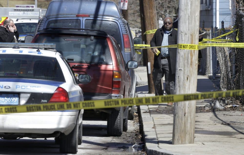 Police tape near a three-story home that was the scene of a fatal shooting in Dorchester in March. (Steven Senne/AP)