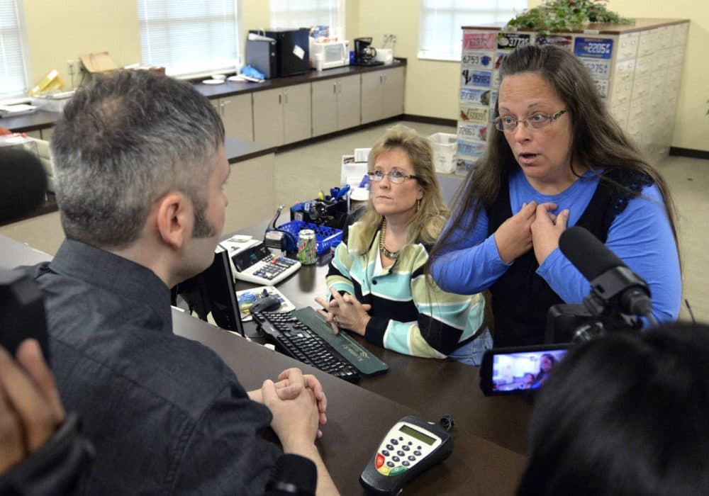 Rowan County Clerk Kim Davis, right, talks with David Moore following her office's refusal to issue marriage licenses at the Rowan County Courthouse in Morehead, Ky. on Tuesday. Although her appeal to the U.S. Supreme Court was denied, Davis still refuses to issue marriage licenses. (Timothy D. Easley/AP)