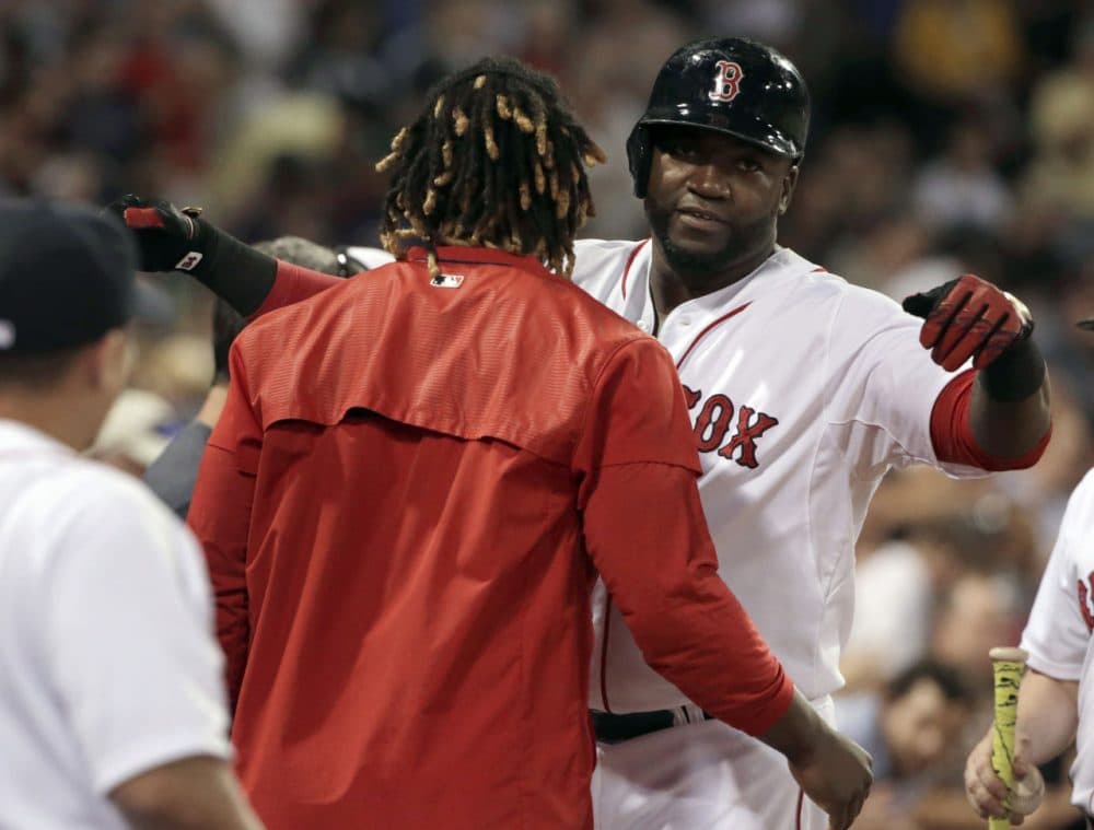 Red Sox designated hitter David Ortiz, right, hugs Hanley Ramirez after hitting a home run against the Yankees, Monday, Aug. 31, 2015, at Fenway. The Red Sox won 4-3. (Steven Senne/AP)