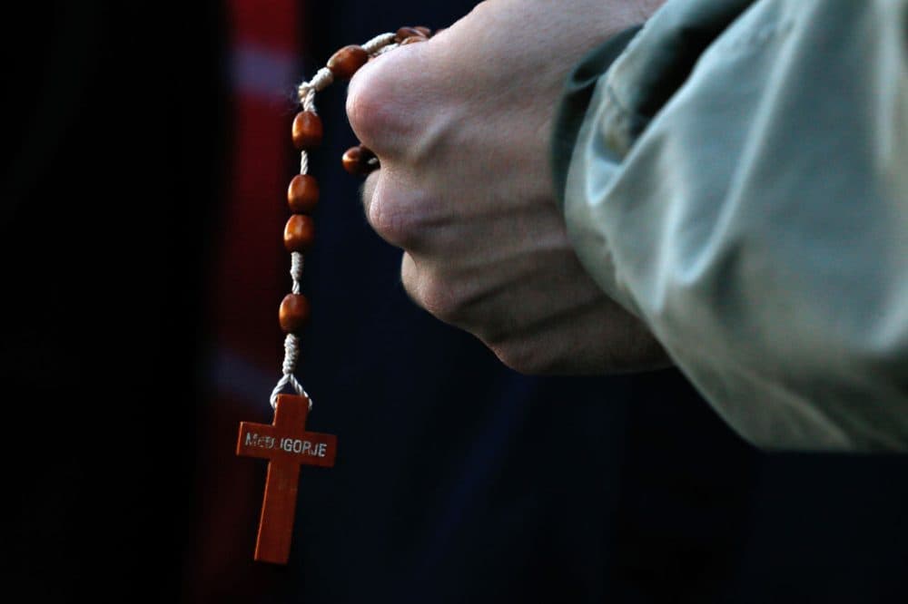 A man holds rosary beads, Saturday, Jan. 24, 2015, in Baton Rouge, La. (Jonathan Bachman/AP)