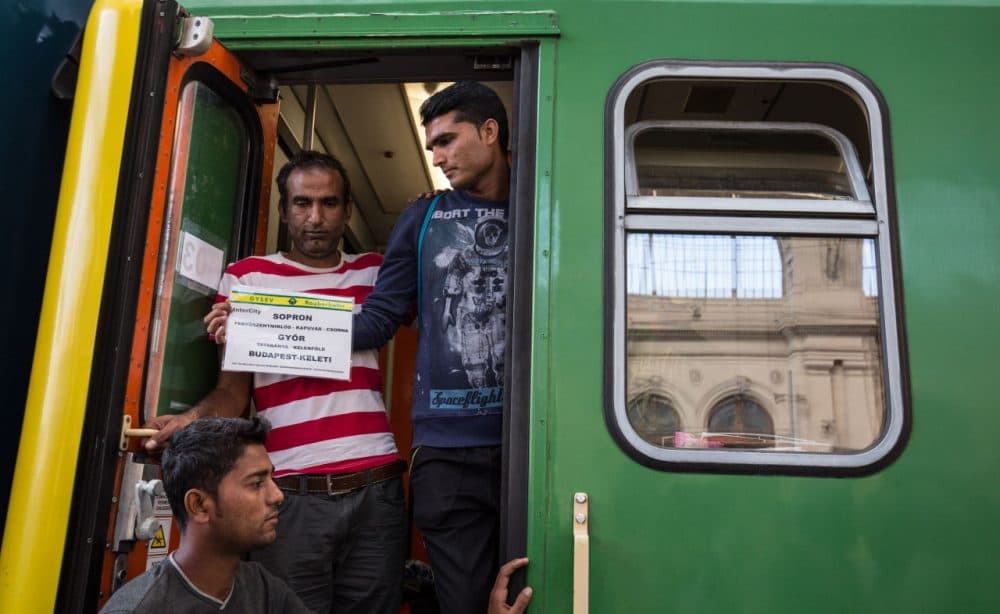 Migrants board a train in Keleti station heading for the border town of Sopron after it was reopened this morning in central Budapest on September 3, 2015 in Budapest, Hungary. Although the station has reopened, all international trains to Western Europe have been cancelled. (Matt Cardy/Getty Images)