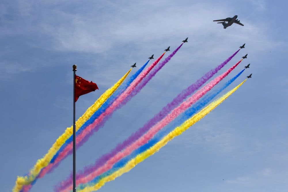 A KJ-2000 airborne early warning and control system leads J-10 fighter jets flying past a national flag during a military parade to mark the 70th anniversary of the end of World War Two on September 3, 2015 in Beijing, China. China is marking the 70th anniversary of the end of World War II and its role in defeating Japan with a new national holiday and a military parade in Beijing. (Andy Wong /Getty Images)