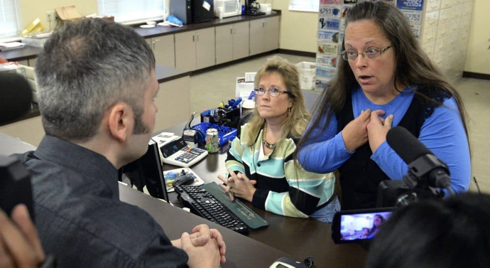 Rowan County Clerk Kim Davis, right, talks with David Moore following her office's refusal to issue marriage licenses at the Rowan County Courthouse in Morehead, Ky., Tuesday, Sept. 1, 2015. Although her appeal to the U.S. Supreme Court was denied, Davis still refuses to issue marriage licenses. (Timothy D. Easley/AP)