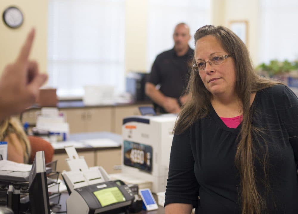 Kim Davis, the Rowan County Clerk of Courts, listens to Robbie Blankenship and Jesse Cruz as they speak with her about getting a marriage license at the County Clerks Office on September 2, 2015 in Morehead, Kentucky. Citing a sincere religious objection, Davis, an Apostolic Christian, has refused to issue marriage licenses to same sex couples in defiance of a Supreme Court ruling. (Ty Wright/Getty Images)