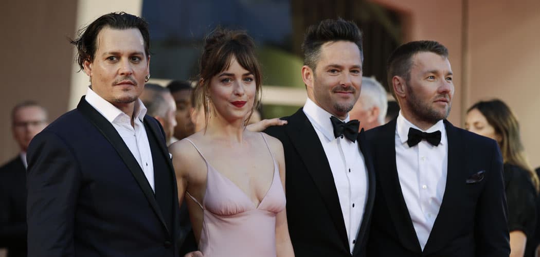 &quot;Black Mass&quot; team (from left, actors Johnny Depp, Dakota Johnson, director Scott Cooper and actor Joel Edgerton) arrive on the red carpet at the 72nd Venice Film Festival, Friday, Sept. 4, 2015. &quot;Spotlight,&quot; based on a Boston Globe investigation, is also debuting there. (Andrew Medichini/AP)