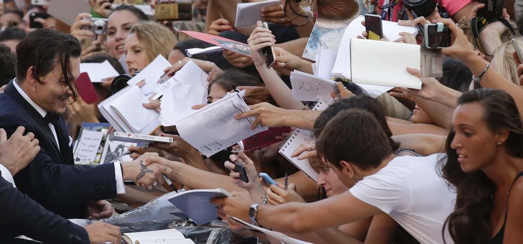 Actor Johnny Depp signs autographs for his fans as he arrives for the screening of the movie &quot;Black Mass&quot; at the 72nd edition of the Venice Film Festival in Venice, Italy, Friday. (Andrew Medichini/AP)