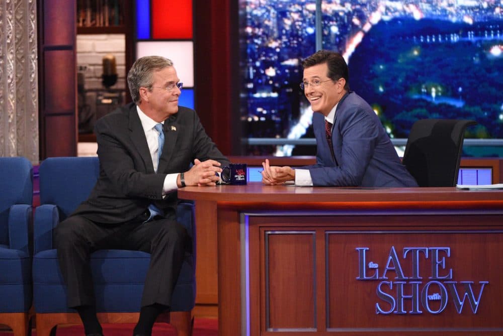 Stephen Colbert, right, talks with Republican presidential candidate Jeb Bush during the premiere episode of &quot;The Late Show,&quot; Tuesday Sept. 8, 2015, in New York. Bush and actor George Clooney were the guests for Colbert's debut. (Jeffrey R. Staab/CBS via AP)