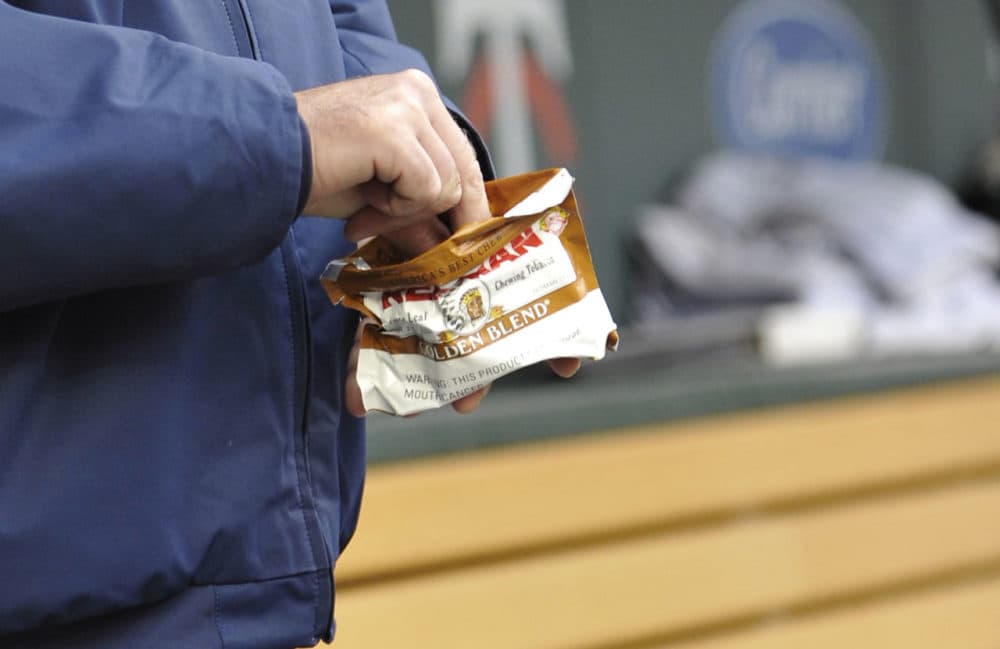 Chewing tobacco, seen here in this 2011 photo, has been a nearly two-century-old habit of many baseball players on the field and in the dugout. Boston passed a citywide ordinance banning all smokeless tobacco products from its sporting venues, effective on April 1, 2016. (Jim Mone/AP)