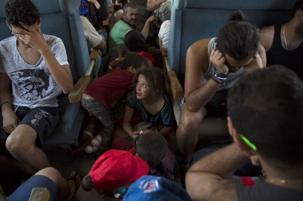 Migrant families ride a train from Gevgelija to the Serbian border on September 4, 2015 in Macedonia. After stopping at a Serbian processing facility for migrants only, most people will continue on foot for the next 6 miles into the Serbian town of Preshevo. Since the beginning of 2015 the number of migrants using the so-called 'Balkans route' has exploded with migrants arriving in Greece from Turkey and then travelling on through Macedonia and Serbia before entering the EU via Hungary. The number of people leaving their homes in war torn countries such as Syria, marks the largest migration of people since World War II. (Dan Kitwood/Getty Images)