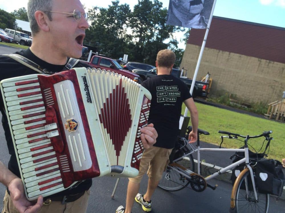 Johnny Clockworks, a member of the Stamp Stampede, performs a song he composed about campaign finance reform at a recent event for Sen. Bernie Sanders. The Stampede is one of many advocacy groups vying for attention in the shadow of the N.H. primary. (Sam Evans-Brown, NHPR)