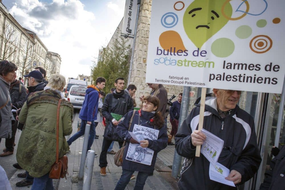 A man holds a placard reading &quot;Bubbles of Sodastream, Tears of Palestinians&quot; during a demonstration in France earlier this year. (Pierre Duffour/AFP/Getty Images)