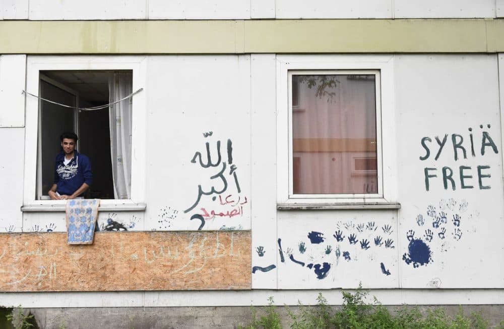 Syrian refugee Abd Alrazak, a 21-year-old from Homs, looks out of the window of his room at a temporary refugee home in Berlin's Spandau district. (Tobias Schwarz/AFP/Getty Images)