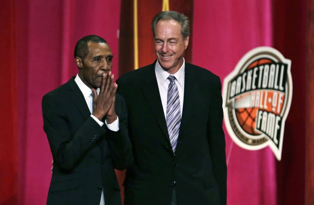 Basketball Hall of Fame inductee Jo Jo White pauses to acknowledge applause during the enshrinement ceremony for the Class of 2015 of the Naismith Memorial Basketball Hall of Fame in Springfield on Friday. At right is White's Boston Celtics teammate, Hall of Famer Dave Cowens. (Charles Krupa/AP)