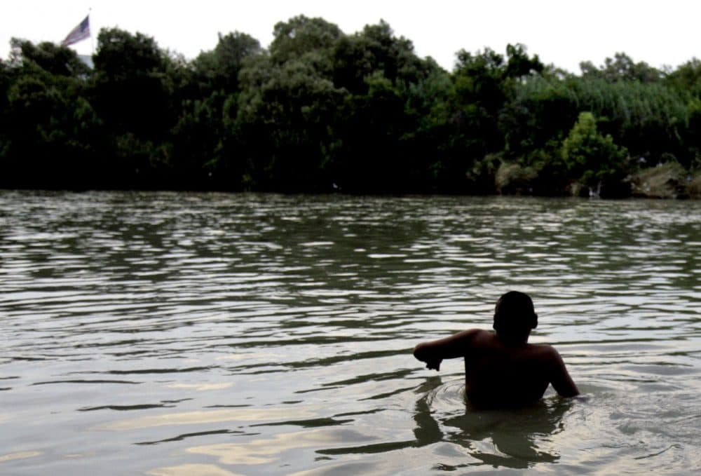 In this June 2, 2007 photo, a migrant begins the swim across the Rio Grande River at the U.S.-Mexico border in Nuevo Laredo, Mexico, just across from Laredo, Texas. Intelligence officials are focusing new attention on these networks that smuggle people from Djibouti, Eritrea, Somalia and Sudan - known havens for terrorists, including al-Qaida - according to an internal government assessment obtained by The Associated Press. (LM Otero/AP)