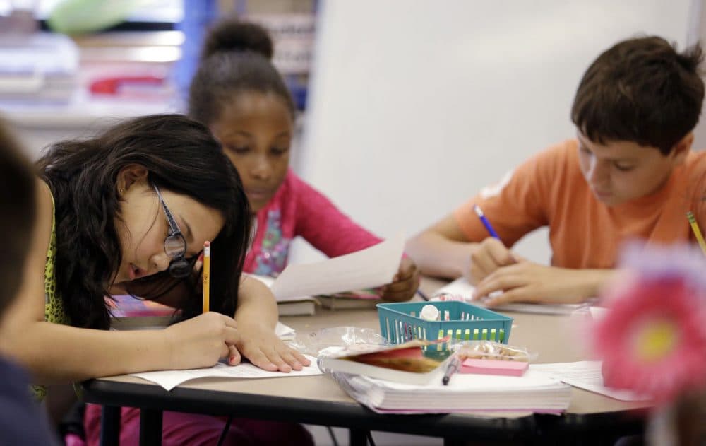 Fifth graders write during class at John Hay Elementary school in Seattle,  Oct. 2, 2014. (Elaine Thompson/AP)