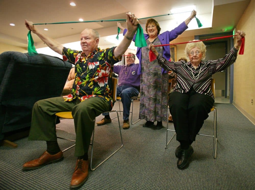 Lynette Sali leads stretching exercises with club members Bob Wecke, Don Willis and Maxinne Read at the Cathedral of the Rockies Methodist Church in downtown Boise, Idaho. Their club provides activities for those suffering from dementia and Alzheimer's. (Troy Maben/AP)