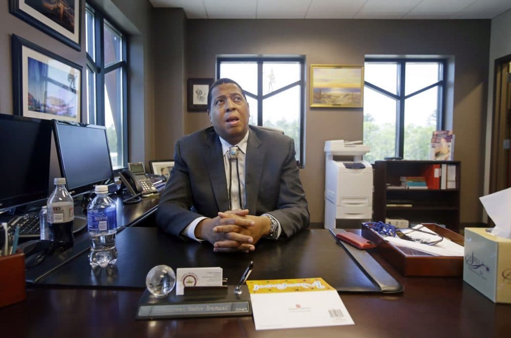 In this May 29, 2014 photo, Mashpee Wampanoag Tribe Chairman Cedric Cromwell sits behind his desk at the community/government Center in Mashpee.(Stephan Savoia/AP)