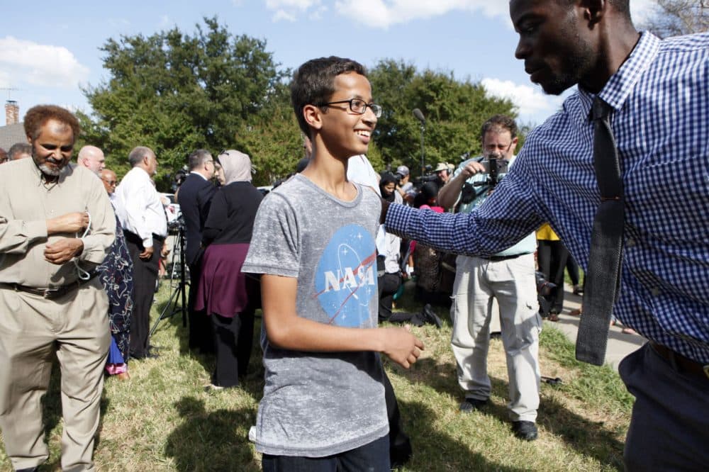 Ahmed Mohamed, 14, is greeted by a supporter during a news conference on Wednesday in Irving, Texas. He was detained after a high school teacher falsely concluded that a homemade clock he brought to class might be a bomb. (Ben Torres/Getty Images)