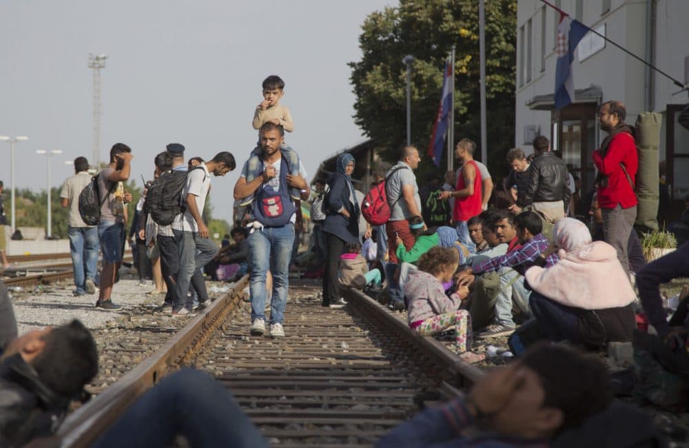 Refugees gather at the train station in Beli Manastir, near the Hungarian border, in northeast Croatia, early Friday. (Darko Bandic/AP)
