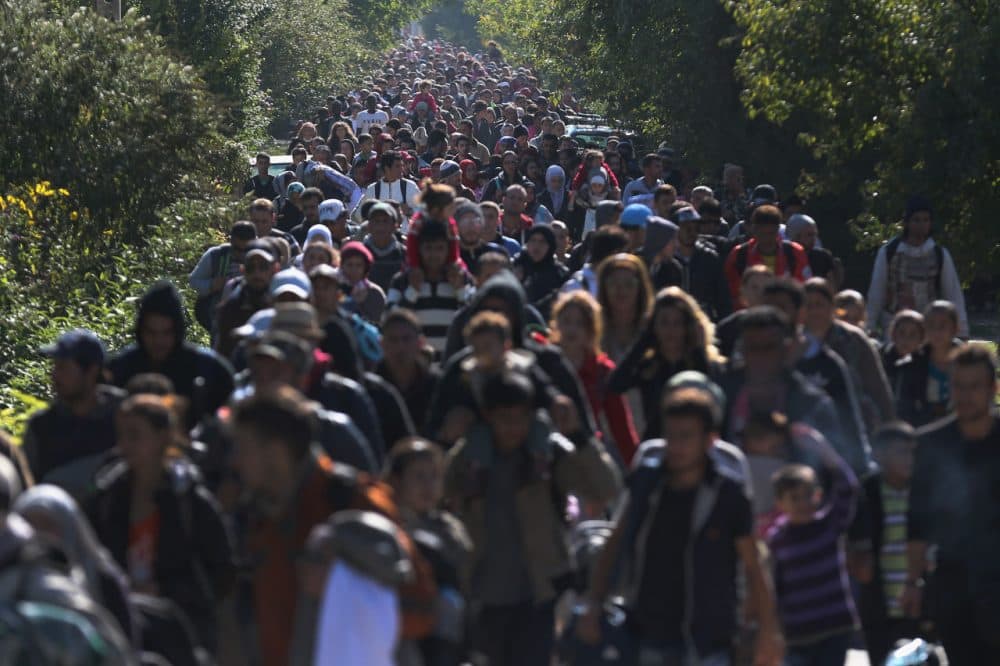 Hundreds of migrants who arrived by train at Hegyeshalom on the Hungarian and Austrian border walk the four kilometers into Austria on September 22, 2015 in Hegyeshalom, Hungary. Politicians across the European Union are holding meetings on the refugee crisis with EU leaders attending a summit on Wednesday to try and solve the crisis and the dispute of how to relocate 120,000 migrants across EU states.  (Christopher Furlong/Getty Images)