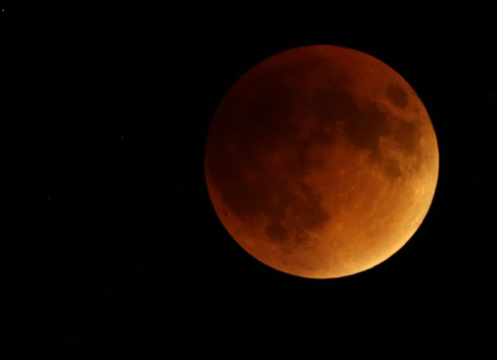 Earth's shadow obscures the view of a so-called supermoon during a total lunar eclipse on Sunday near Lecompton, Kan. (Orlin Wagner/AP)