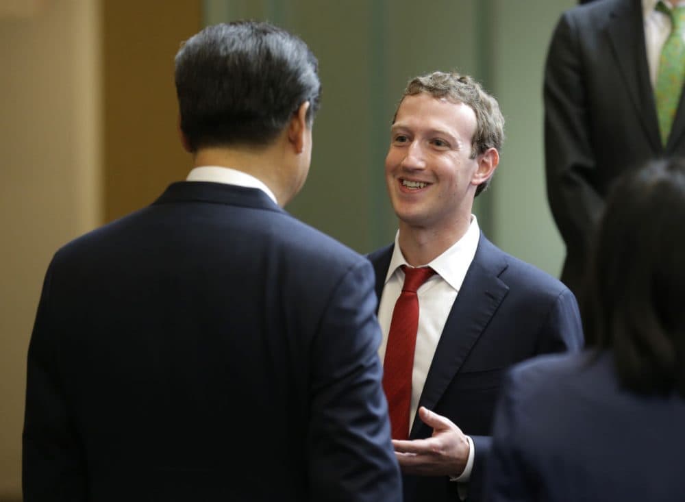 Chinese President Xi Jinping, left, talks with Facebook Chief Executive Mark Zuckerberg, right, during a gathering of CEOs and other executives at Microsoft's main campus September 23, 2015 in Redmond, Washington. Xi and top executives from U.S. and Chinese companies discussed a range of issues, including trade relations, intellectual property protection, regulation transparency and clean energy, according to published reports. (Ted S. Warren/Getty Images)