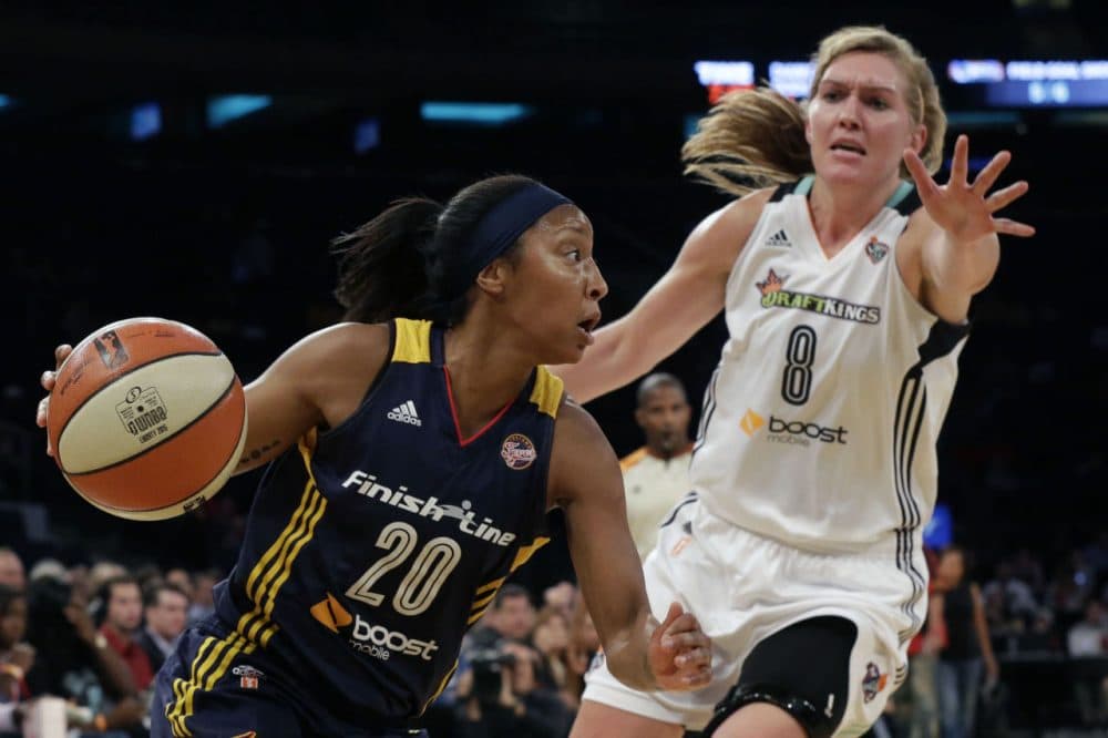 Indiana Fever guard Briann January (20) drives to the basket past New York Liberty center Carolyn Swords (8) during Game 1 of the WNBA basketball Eastern Conference finals on Sept. 23, 2015 at Madison Square Garden in New York.  (Mary Altaffer/AP)