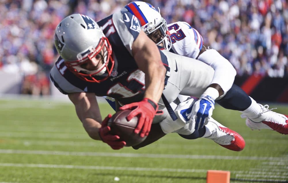 New England Patriots wide receiver Julian Edelman (11) dives past Buffalo Bills free safety Aaron Williams (23) for a touchdown during the second half of a game Sunday, Sept. 20, 2015. (Gary Wiepert/AP)