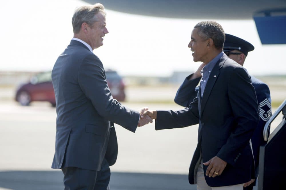 Gov. Charlie Baker greets President Obama at Logan Airport Monday. Obama was in Boston to speak at the the Greater Boston Labor Council's Labor Day breakfast. (Andrew Harnik/AP)