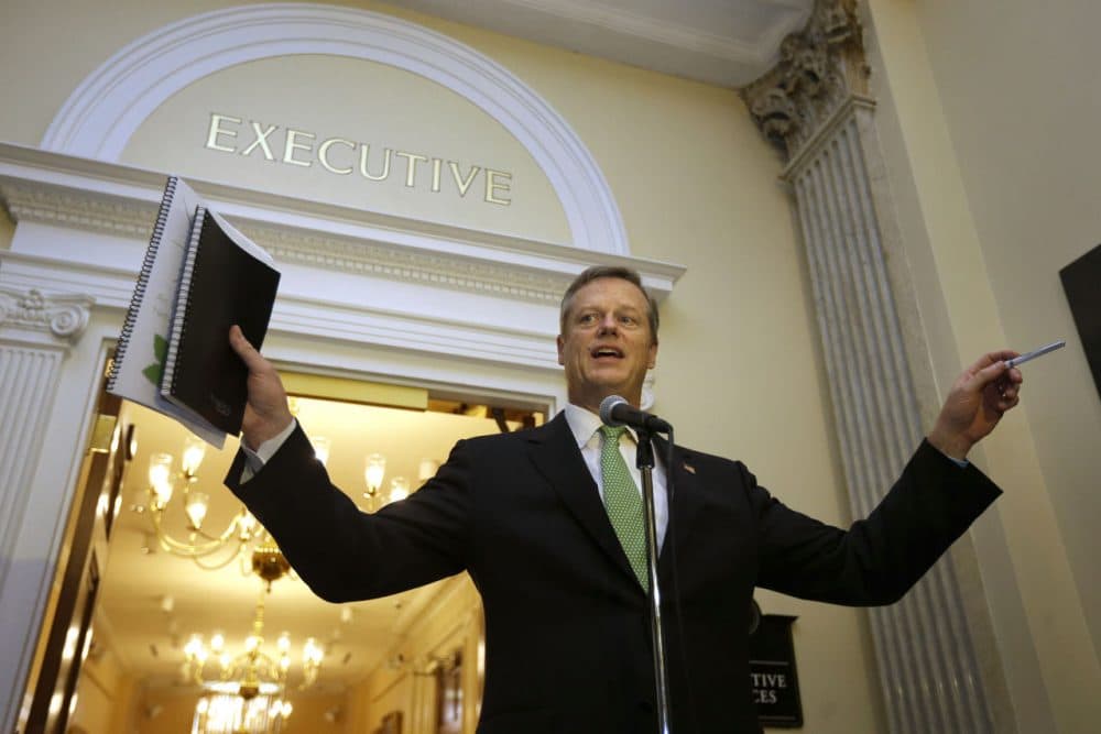 Gov. Charlie Baker speaks with reporters outside his office Wednesday, after discussing the North-South rail link with former Govs. Michael Dukakis and William Weld. (Steven Senne/AP)