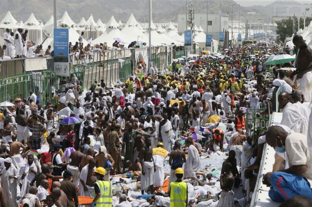 Muslim pilgrims and rescuers gather around the victims of a stampede in Mina, Saudi Arabia during the annual hajj pilgrimage on Thursday, Sept. 24, 2015. (AP)