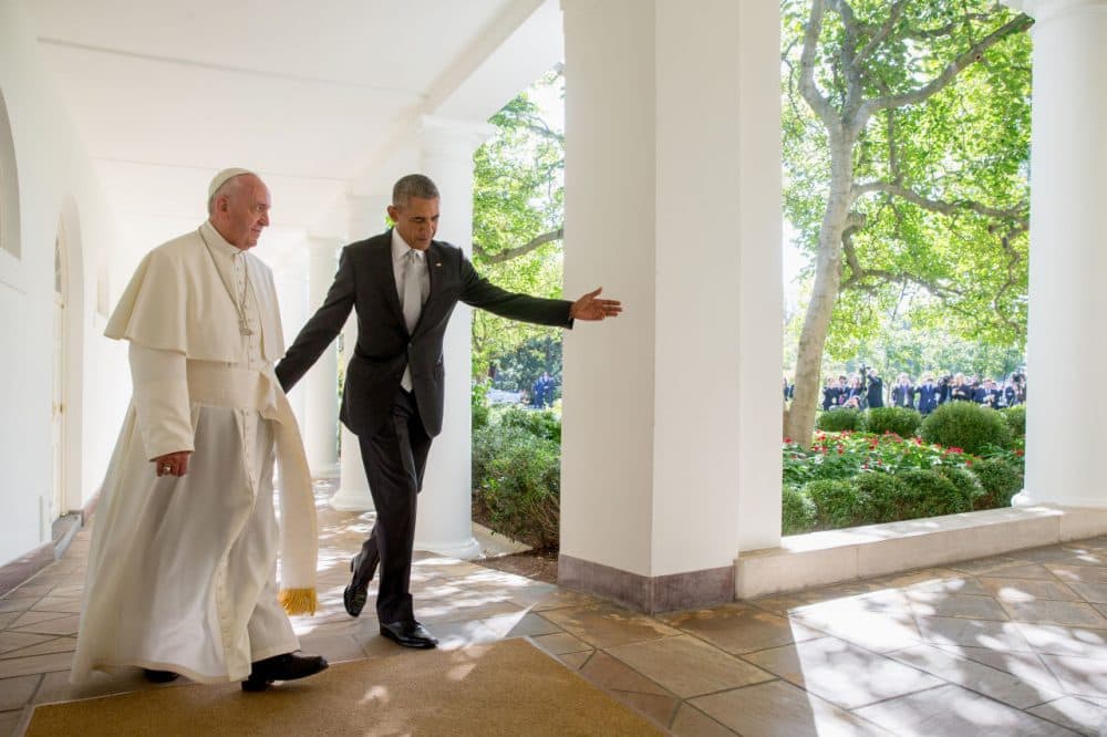 President Obama and Pope Francis walk down the Colonnade before meeting in the Oval Office Wednesday. (Andrew Harnik/AP)