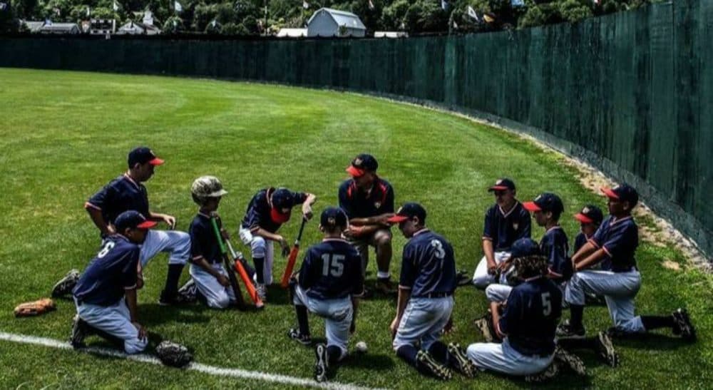 Ted Flanagan: &quot;In the hills outside of Cooperstown this past July, 11 boys reminded me that there is still joy to be had in picking up the lance and jousting at windmills. There’s more than one way to be built to win.&quot; Pictured: The author and the Lions talk strategy in right field before a game in July, 2015, at the annual Cooperstown Dreams Park Tournament. (Alex Belisle/Courtesy)