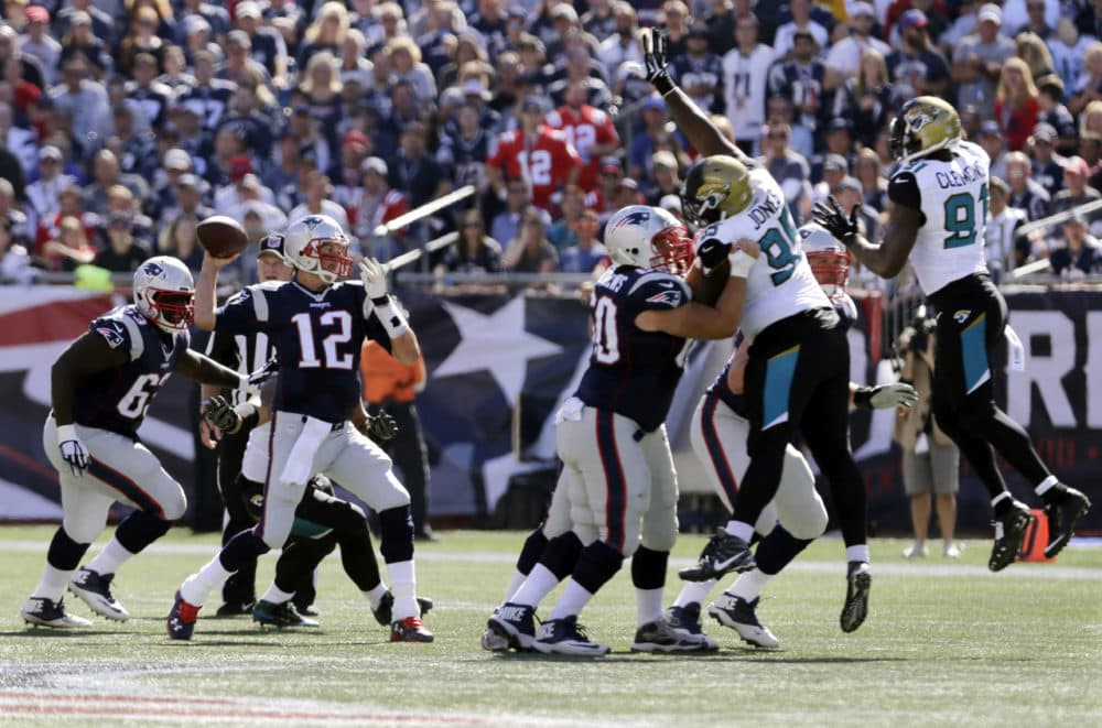 New England Patriots quarterback Tom Brady (12) passes against the rush by Jacksonville Jaguars defensive tackle Abry Jones (95) and Jaguars defensive end Ziggy Hood (92) in the first half of an NFL football game on Sunday in Foxborough, Mass. (Charles Krupa/AP)