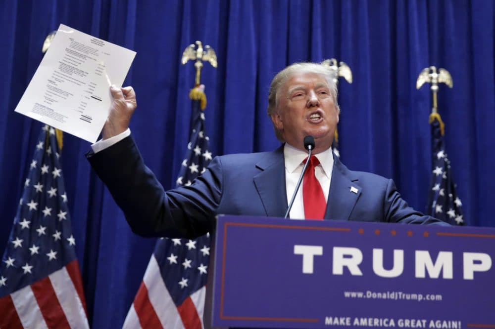 Developer Donald Trump displays a copy of his net worth during his announcement that he will seek the Republican nomination for president, Tuesday, June 16, 2015, in the lobby of Trump Tower in New York. (AP Photo/Richard Drew)