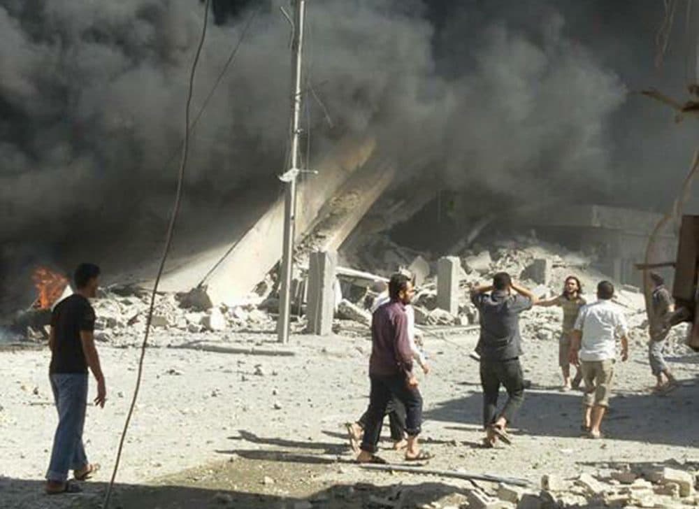 This image taken Wednesday, Sept. 30, 2015, posted on the Twitter account of Syria Civil Defence, also known as the White Helmets, a volunteer search and rescue group, shows the aftermath of an airstrike in Talbiseh, Syria. Russia on Wednesday carried out its first airstrikes in Syria in what President Vladimir Putin called a preemptive strike against the militants. Khaled Khoja, head of the Syrian National Council opposition group, said at the U.N. that Russian airstrikes in four areas, including Talbiseh, killed dozens of civilians, with children among the dead. (Syria Civil Defence via AP)