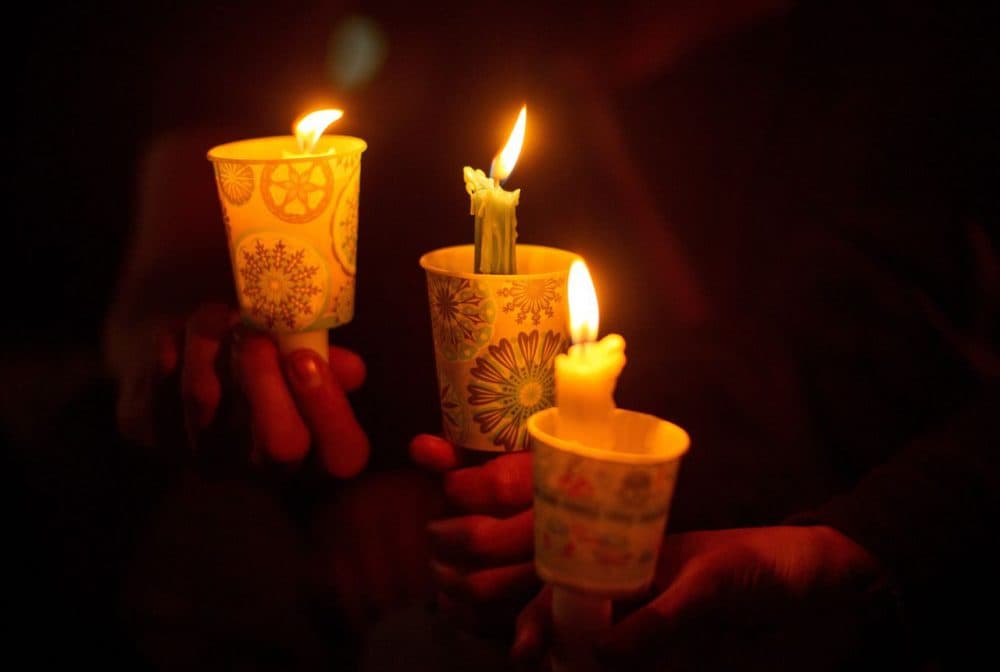 People hold candles during a vigil in Roseburg, Oregon on October 1, 2015, for nine people killed and seven others wounded in a shooting at a community college in Oregon. The shooter, identified by U.S. media as Chris Harper Mercer, 26, opened fire in a classroom at Umpqua Community College in rural Roseburg, then moved to other rooms methodically gunning down his victims, witnesses said. (Josh Edelson/AFP/Getty Images)