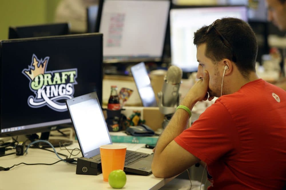 Devlin D'Zmura, a DraftKings employee, works on his laptop at the company's offices in Boston. (Stephan Savoia/AP)