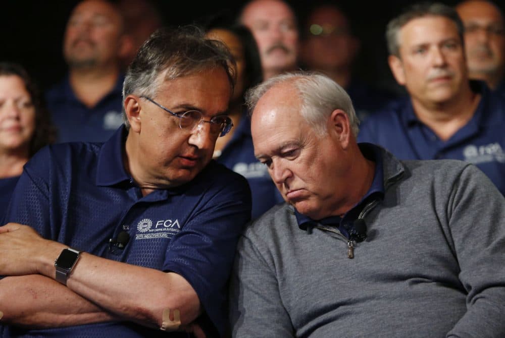 Fiat Chrysler Automobiles CEO Sergio Marchionne, left, and United Auto Workers President Dennis Williams talk during a ceremony to mark the opening of contract negotiations in Detroit, July 14, 2015. (Paul Sancya/AP)