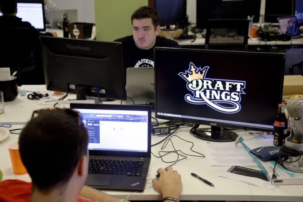 Len Don Diego, marketing manager for content at DraftKings, a daily fantasy sports company, works at his station at the company's offices in Boston. (Stephan Savoia, File/AP)