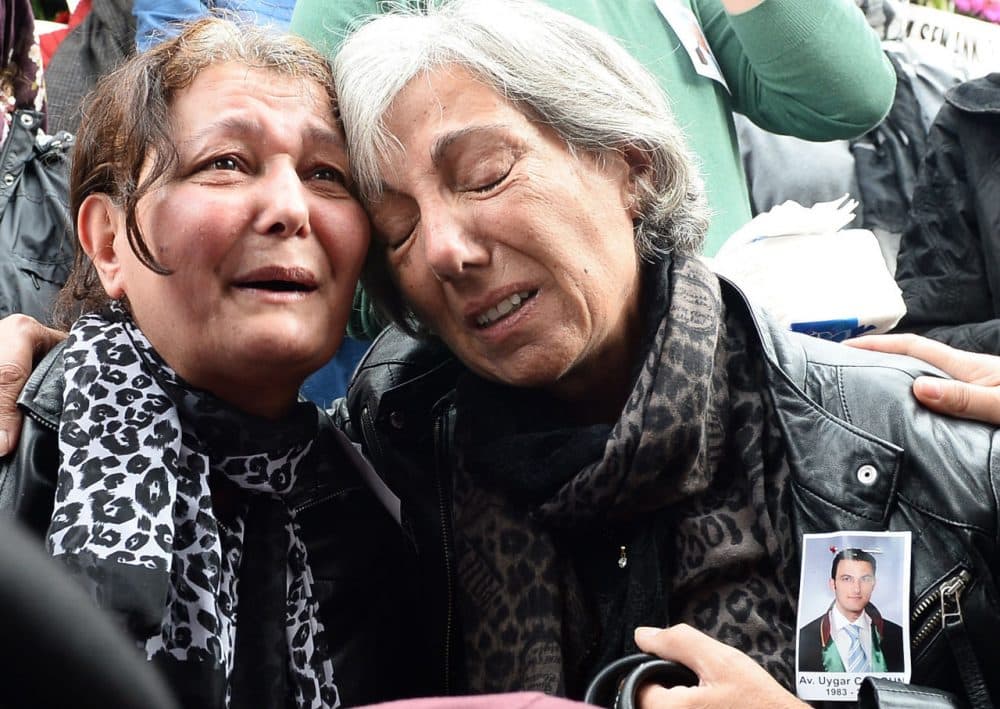 Mourners express their grief at the funeral of 32 year-old Uygar Coskun, one of the victims in the twin bomb attacks, in Ankara on October 12, 2015. After several days of silence and uncertainty, Turkey has formally pointed the finger at the Islamic State over the weekend bombing in Ankara. The development comes amid growing anger towards President Erdogan over the attack which came just three weeks ahead of elections. (STR/AFP/Getty Images)