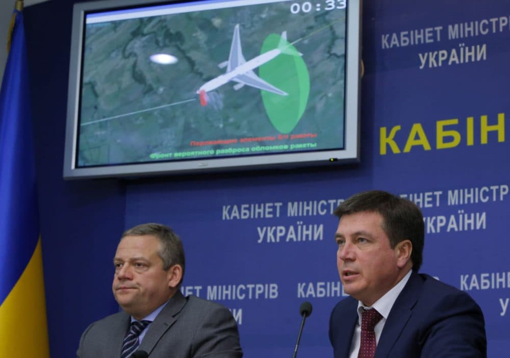 Vice Prime Minister and chairman of the government commission to investigate the causes of the MH17 crash Hennadiy Zubko, right, speaks at a briefing for journalists in Kiev, Ukraine, Tuesday, Oct. 13, 2015. Investigators said the Buk missile that downed Malaysia Airlines Flight 17 exploded less than a meter from the cockpit, killing the two pilots and the purser inside in an instant and breaking off the front of the plane. The tragedy that killed all 298 people aboard the plane on July 17, 2014, wouldn’t have happened if anyone had thought to close the airspace of eastern Ukraine to passenger planes as fighting raged below, the Dutch Safety Board said.  (Sergei Chuzavkov/AP Photo)