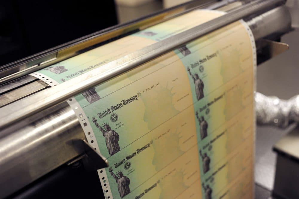 Blank social security checks run through a printer at the U.S. Treasury printing facility in Philadelphia, Pennsylvania. (William Thomas Cain/Getty Images)