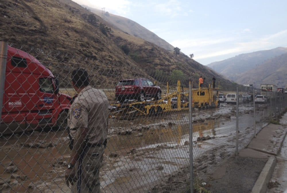 In a photo provided by Caltrans, water and mud cover Interstate 5 at Fort Tejon, about 75 miles north of downtown Los Angeles, on Thursday, Oct. 15, 2015. Flash flooding sent water, mud and rocks rushing across Interstate 5, stranding hundreds of vehicles and closing the major north-south thoroughfare. (Caltrans via AP)