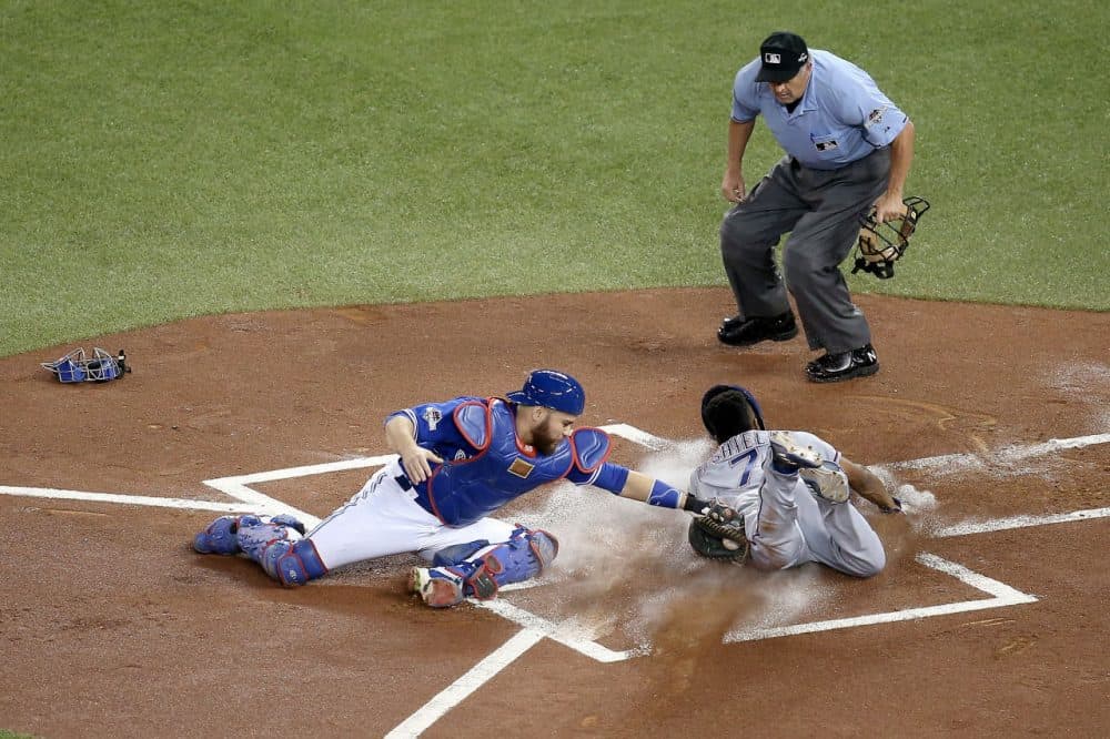 Delino DeShields #7 of the Texas Rangers slides into home safely ahead of the tag by Russell Martin #55 of the Toronto Blue Jays in the first inning against the Toronto Blue Jays in game five of the American League Division Series at Rogers Centre on October 14, 2015 in Toronto, Canada. (Tom Szczerbowski/Getty Images)