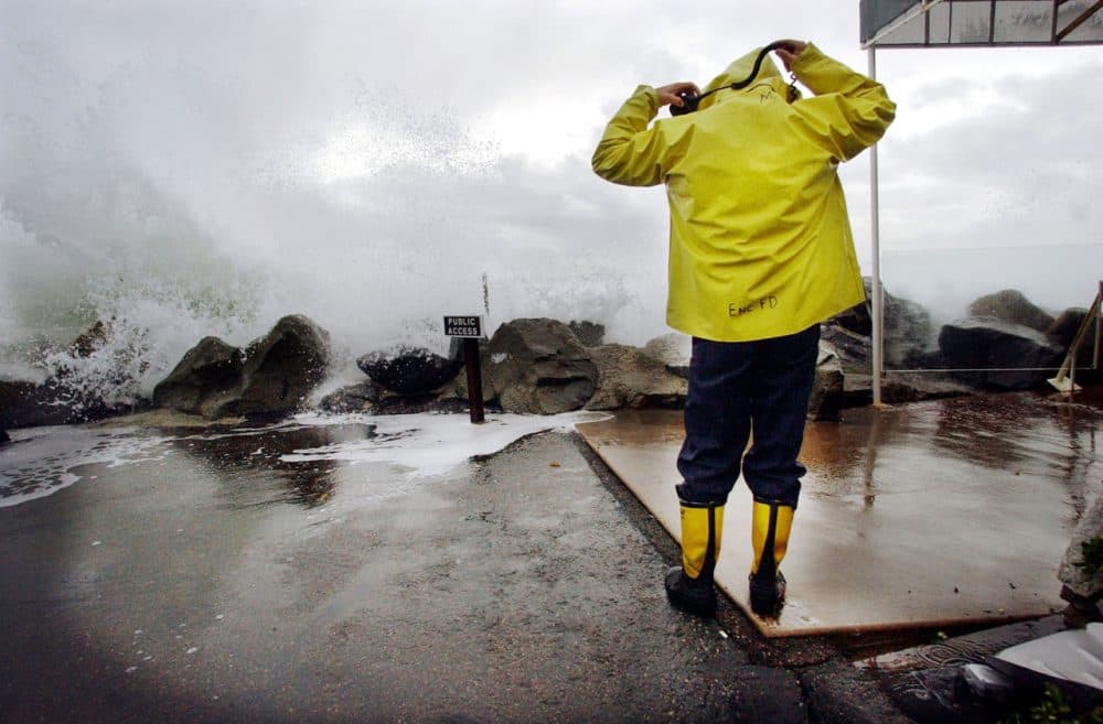 Heavy rains and large surf pounded the West Coast as a product of El Nino in December 2002. Another El Nino is supposed to hit the area, leaving many wondering how to store the rain for drier times. Here, Encinitas fireman Mike Kemp adjusts his hood as a wave crashes over a sea wall December 20, 2002 in Cardiff-by-the-Sea, California as firemen worked to help clear flooded buildings. (Sandy Huffaker/Getty Images)